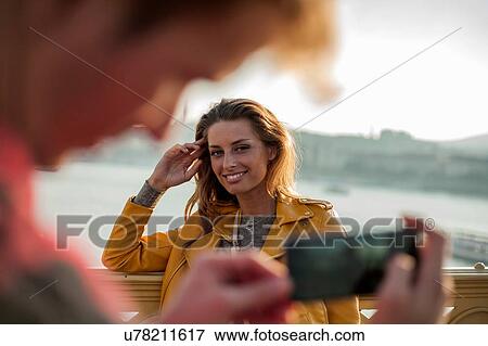 Couple taking photos using smartphone View Large Photo Image Stock Photo - Couple taking photos using smartphone. Fotosearch