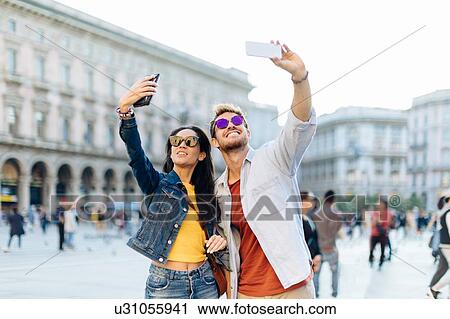 Couple taking selfie, Piazza del Duomo, Milan, Italy View Large Photo Image Stock Image - Couple taking selfie, Piazza del Duomo, Milan, Italy. Fotosearch