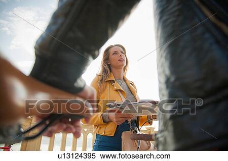 Cyclist and woman stopping to read map View Large Photo Image Stock Photography - Cyclist and woman stopping to read map. Fotosearch