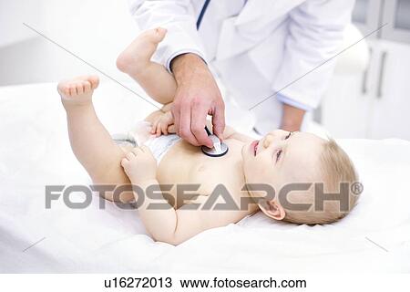 Stock Image - Doctor examining baby with stethoscope.. Fotosearch