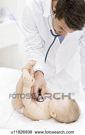 Stock Photo - Doctor examining baby with stethoscope.. Fotosearch