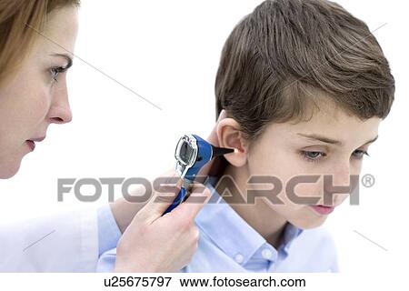 Doctor examining boy's ear with an otoscope. View Large Photo Image Stock Photo - Doctor examining boy's ear with an otoscope.. Fotosearch