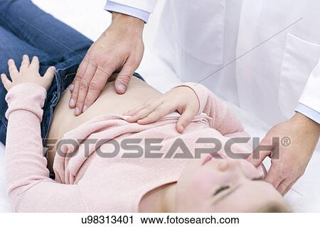 Doctor examining girl's abdomen View Large Photo Image Stock Image - Doctor examining girl's abdomen. Fotosearch