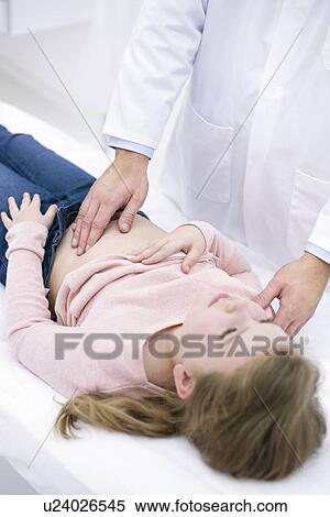 Doctor examining girl's abdomen View Large Photo Image Stock Photography - Doctor examining girl's abdomen. Fotosearch