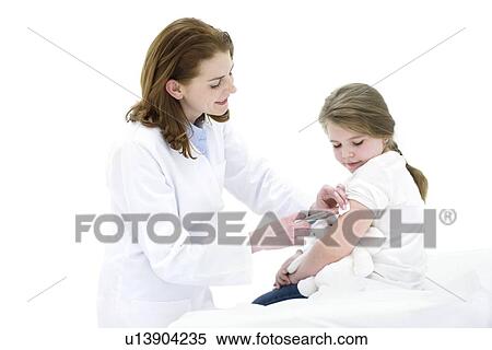 Stock Photography - Female doctor injecting young girl in arm.. Fotosearch