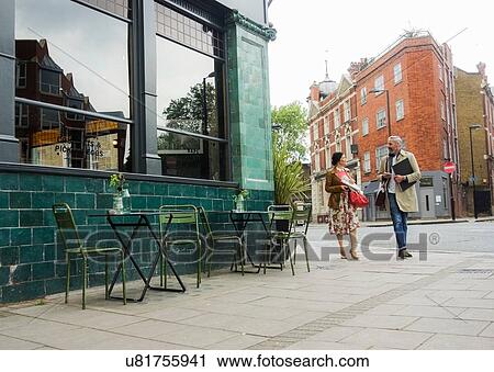 Friends walking by pavement cafe, London, UK View Large Photo Image Stock Image - Friends walking by pavement cafe, London, UK. Fotosearch