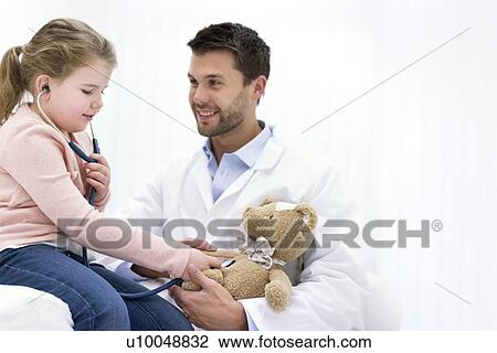 Girl playing with teddy bear and stethoscope. View Large Photo Image Stock Image - Girl playing with teddy bear and stethoscope.. Fotosearch