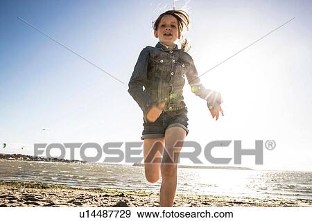 Girl running on beach View Large Photo Image Stock Photo - Girl running on beach. Fotosearch