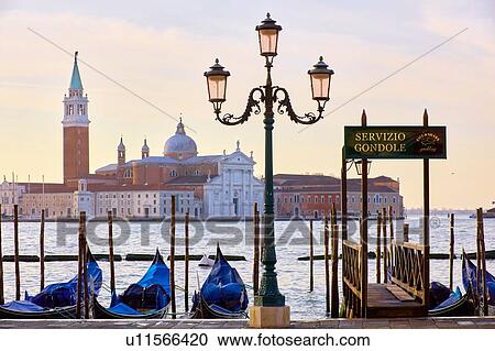 Stock Image - Gondolas on St Marks square waterfront with San Giorgio Maggiore church in background, Venice, Veneto, Italy. Fotosearch