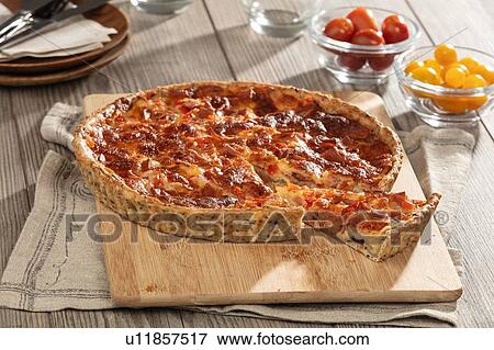 Ham and cheese flan on chopping board, still life View Large Photo Image Stock Photo - Ham and cheese flan on chopping board, still life. Fotosearch