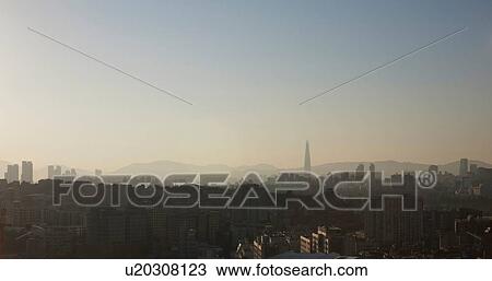 Stock Image - Hazy cityscape and skyline at dusk, Seoul, South Korea. Fotosearch
