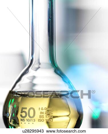 Stock Image - Laboratory beaker containing chemical formula. Fotosearch