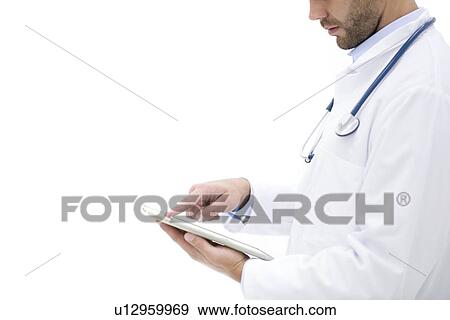Stock Photo - Male doctor using digital tablet.. Fotosearch