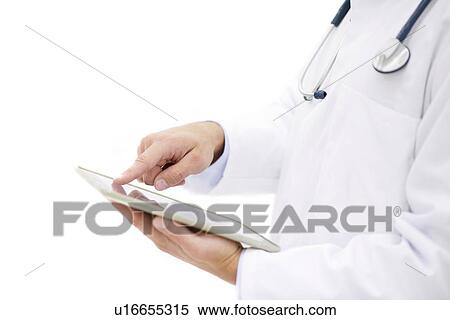 Stock Photography - Male doctor using digital tablet.. Fotosearch