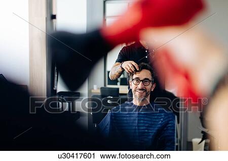 Male hairstylist blow drying male customer's hair in hair salon View Large Photo Image Stock Image - Male hairstylist blow drying male customer's hair in hair salon. Fotosearch