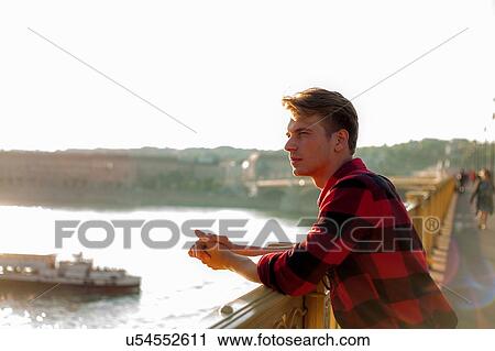Stock Image - Man enjoying view from bridge, Budapest, Hungary. Fotosearch