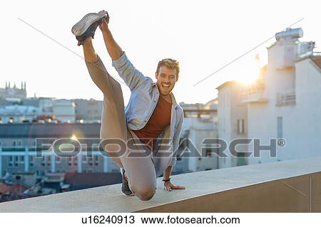 Man on edge of rooftop terrace, Milan, Italy View Large Photo Image Stock Image - Man on edge of rooftop terrace, Milan, Italy. Fotosearch