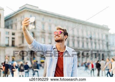 Man taking selfie, Piazza del Duomo, Milan, Italy View Large Photo Image Stock Photo - Man taking selfie, Piazza del Duomo, Milan, Italy. Fotosearch