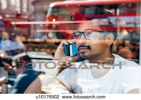 Man using smartphone in cafe View Large Photo Image Stock Image - Man using smartphone in cafe. Fotosearch