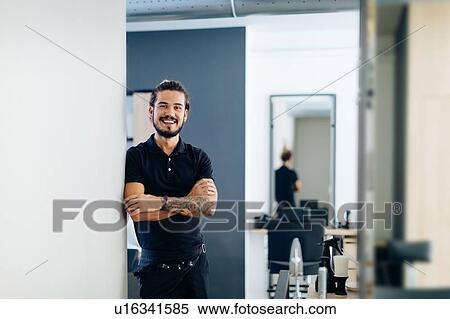 Stock Photography - Mid adult male hairstylist in hair salon, portrait. Fotosearch