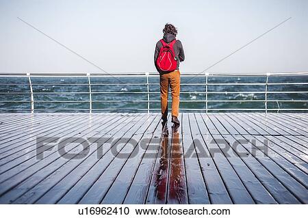 Mid adult man looking out from pier to sea, rear view, Odessa, Odeska Oblast, Ukraine View Large Photo Image Stock Image - Mid adult man looking out from pier to sea, rear view, Odessa, Odeska Oblast, Ukraine. Fotosearch