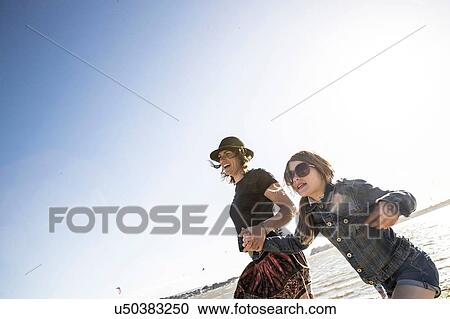Mother and daughter on beach View Large Photo Image Stock Image - Mother and daughter on beach. Fotosearch
