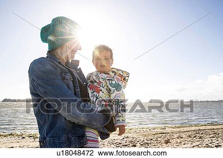 Mother and toddler girl on beach View Large Photo Image Stock Image - Mother and toddler girl on beach. Fotosearch