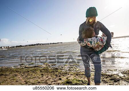 Mother and toddler girl on beach View Large Photo Image Stock Photograph - Mother and toddler girl on beach. Fotosearch