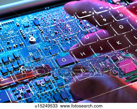 Stock Image - Multiple exposure of a laptop computer showing a invisible computer hacker working at a keyboard and circuit board below. Fotosearch