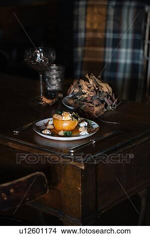 Picture - Plate with stuffed fruit dessert on rustic table. Fotosearch