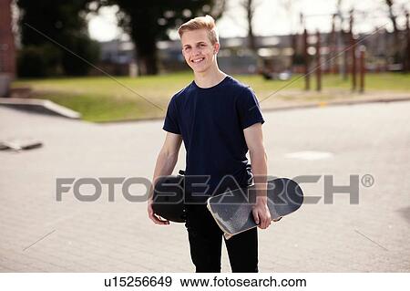 Stock Photo - Portrait of teenage skateboarder. Fotosearch