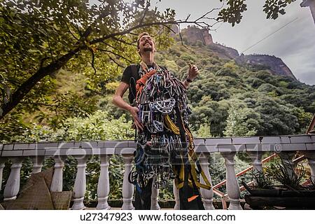 Rock climber covered with safety harness, Liming, Yunnan, China View Large Photo Image Stock Image - Rock climber covered with safety harness, Liming, Yunnan, China. Fotosearch