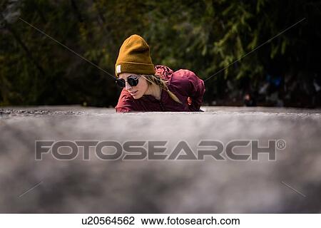 Stock Image - Rock climber gripping onto cracks, Malamute, Squamish, Canada. Fotosearch
