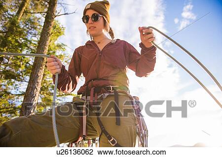 Stock Image - Rock climber using safety harness ropes, Malamute, Squamish, Canada. Fotosearch