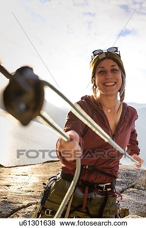 Stock Photo - Rock climber using safety harness ropes, Malamute, Squamish, Canada. Fotosearch