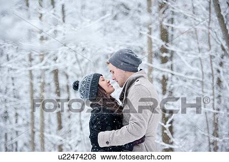 Romantic young couple face to face in snowy forest, Ontario, Canada View Large Photo Image Stock Photo - Romantic young couple face to face in snowy forest, Ontario, Canada. Fotosearch