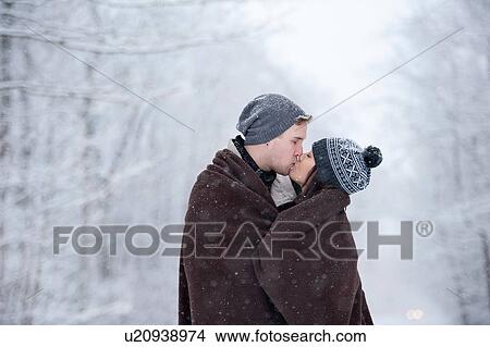 Romantic young couple kissing in snowy forest, Ontario, Canada View Large Photo Image Picture - Romantic young couple kissing in snowy forest, Ontario, Canada. Fotosearch