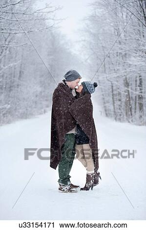 Romantic young couple kissing in snowy forest, Ontario, Canada View Large Photo Image Stock Image - Romantic young couple kissing in snowy forest, Ontario, Canada. Fotosearch