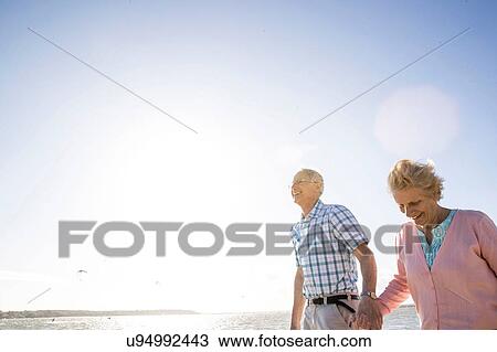Senior adult couple enjoying beach View Large Photo Image Stock Image - Senior adult couple enjoying beach. Fotosearch