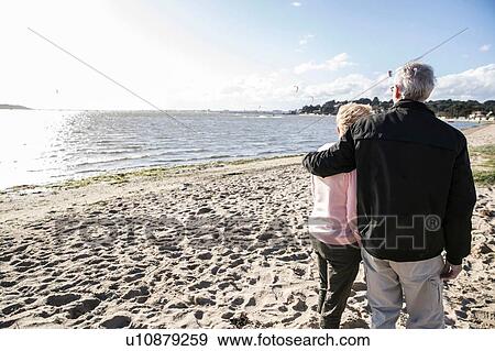Senior adult couple enjoying beach View Large Photo Image Stock Photo - Senior adult couple enjoying beach. Fotosearch