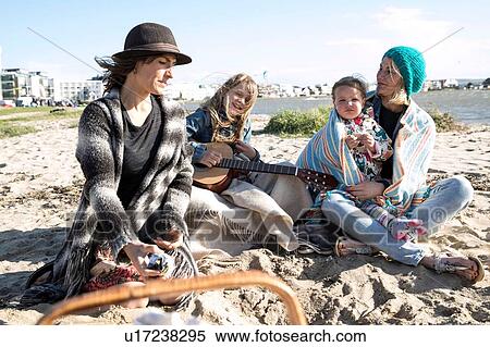 Sisters and their children enjoying beach View Large Photo Image Stock Photography - Sisters and their children enjoying beach. Fotosearch