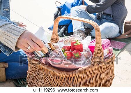 Sisters enjoying picnic on beach View Large Photo Image Stock Photograph - Sisters enjoying picnic on beach. Fotosearch
