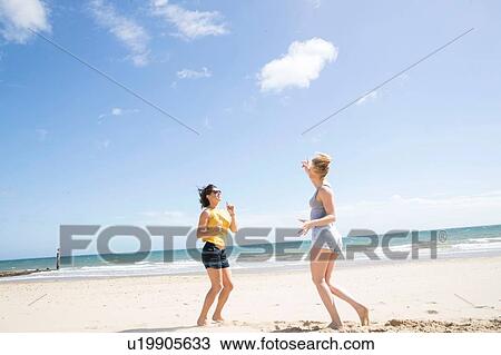 Sisters enjoying themselves on beach View Large Photo Image Stock Image - Sisters enjoying themselves on beach. Fotosearch