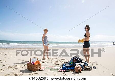 Stock Photography - Sisters enjoying themselves on beach. Fotosearch