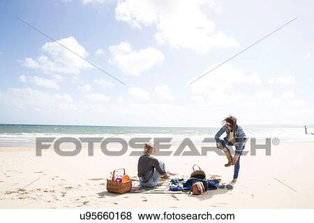 Sisters leaving after picnic on beach View Large Photo Image Stock Photo - Sisters leaving after picnic on beach. Fotosearch