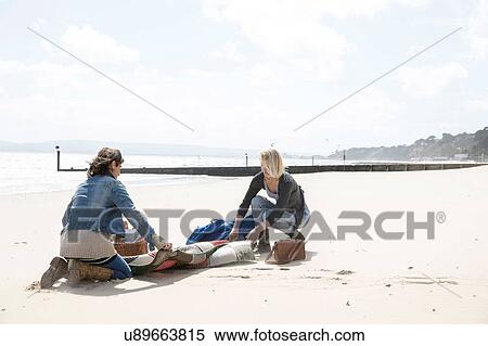 Sisters leaving after picnic on beach View Large Photo Image Stock Photography - Sisters leaving after picnic on beach. Fotosearch