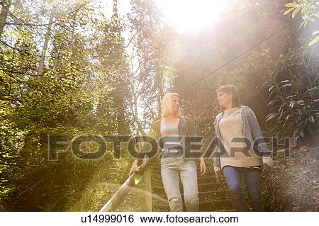 Stock Photograph - Sisters walking in park. Fotosearch