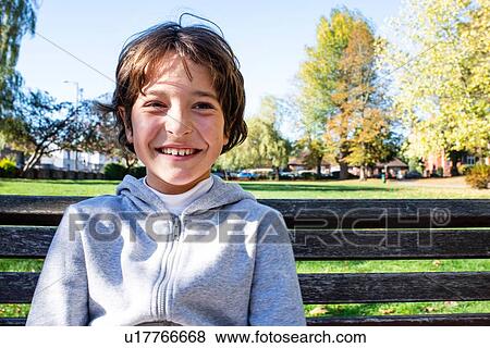 Stock Photo - Smiling boy in park. Fotosearch