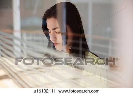 Teenage girl reading text message on cellphone by glass wall View Large Photo Image Stock Image - Teenage girl reading text message on cellphone by glass wall. Fotosearch