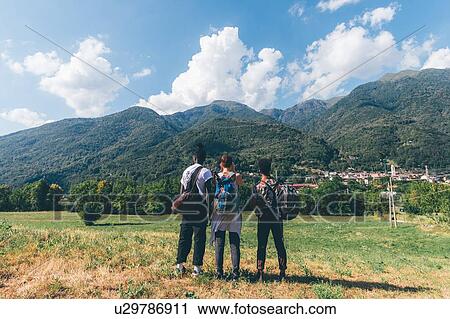 Three young hiking friends looking towards mountains, rear view, Primaluna, Trentino-Alto Adige, Italy View Large Photo Image Stock Image - Three young hiking friends looking towards mountains, rear view, Primaluna, Trentino-Alto Adige, Italy. Fotosearch